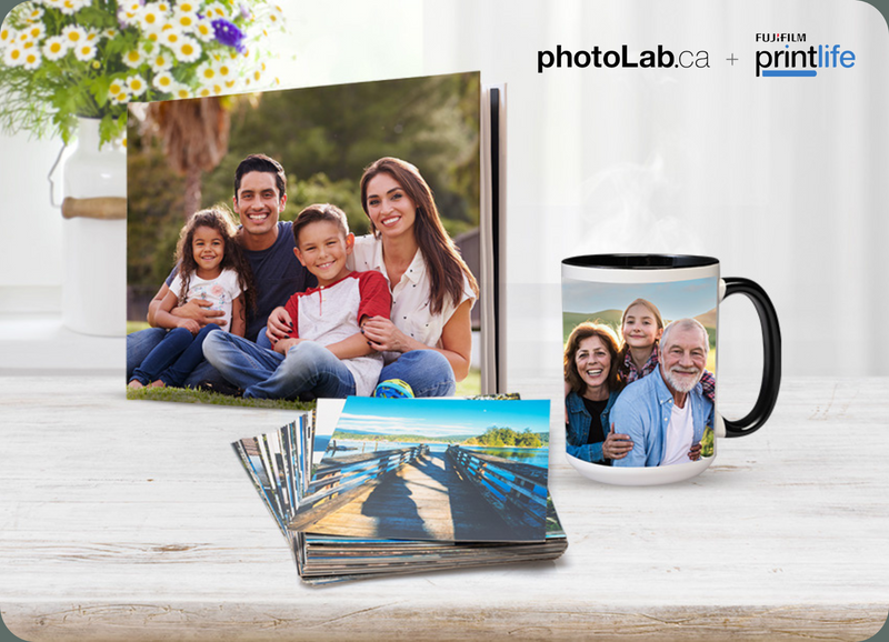 Photo album, mug, and photo prints on a table with 'photoLab.ca' and 'printlife' branding.